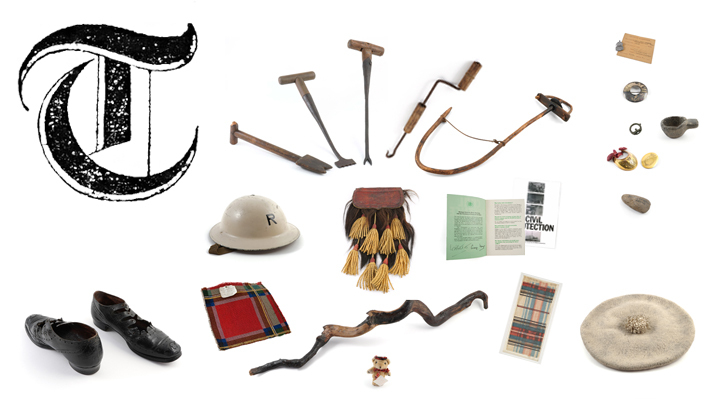 A large ornate printed capital letter T with tartan samples, a walking stick, thatching tools, a pair of shoes, a bonnet, a helmet and some archaeological objects.