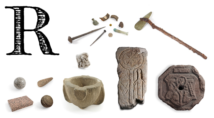 A large printed capital letter R with stone carvings, an axe, a bottle, a coin, a medal and some metal fragments.