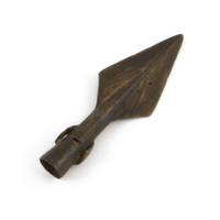 Spearhead. A bronze socketed spearhead about six inches long. The point is large and wide, taking up half the length. There is a small loop on either side of the socket.