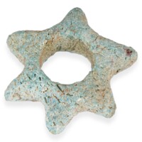 Bead. A small pale blue star shaped bead with six points and a hole in the centre, made of a rough ceramic like material.