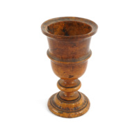 Communion cup. A turned wooden goblet with decorative rings around the middle, stem and foot.