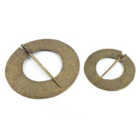 Brooches. Two large, flat ring shaped brass brooches decorated with foliage and knotwork, with fastening pins.