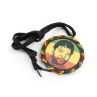 Nelson Mandela gong. A black plastic medallion with green, yellow and red cord wrapped around the edge. The surface of the medallion has a background of horizontal green, yellow and red bands and a portrait of Nelson Mandela printed in black on it. A black shoelace is tied to the medallion.