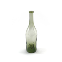 Wine bottle. A light green glass bottle with a boar&#039;s head and the letter E surrounded by a ring on the lower body.