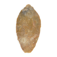 Spear point. An orange flint spear point about 9 centimetres long, roughly oval shaped.