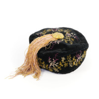 Smoking cap. A black cap with purple and green embroidered foliage and yellow and pink tassels.