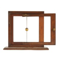 Diagonal machine. A small square wooden frame, about a foot wide. A slightly smaller frame slides horizontally out. A brass ball on a string and attached to a pulley on the smaller frame moves diagonally upwards as the frame is slid horizontally.