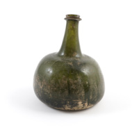 Bottle. A deep green glass bottle with a very wide, squat body, covered in scratches and stains toward the bottom.