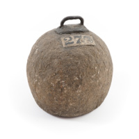 Weight. A ball of granite, about seven inches tall, with an iron handle on top.