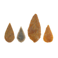 Flint arrowheads. Four leaf shaped arrowheads in orange and grey flint.