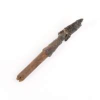 Arrowhead. An iron arrowhead with part of a wooden shaft. The arrowhead has a socket which fits over the shaft.