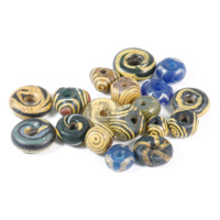 Pictish beads. Nineteen glass beads in ring and rounded triangle shapes. The triangular beads are of brown and blue glass with opaque yellow spirals on them, and the ring shaped beads are in blue, white, yellow, green and grey glass in swirly patterns.