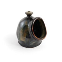 Salt pig. A swirly dark green and brown glazed ceramic vessel, in the shape of a tall dome with a handle on top and a wide rimmed opening on the side.