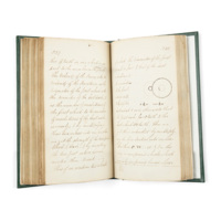 Notebook. An open manuscript book with a diagram of two connected toothed wheels, one smaller than the other, with weights hanging from them, and explanatory text.
