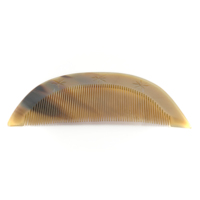 Comb. Flat comb with a wide arch shape made of tortoiseshell. Three stars are cut into the handle.