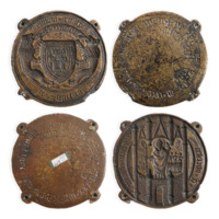 Replica seal matrix. Two bronze moulds, one with a coat of arms with a tower on it and a lion on either side, the other with a bishop standing in a tower.
