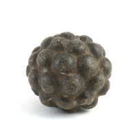 Carved stone ball. Roughly the size of a tennis ball. Dark grey, polished stone ball with 42 small round knobs.