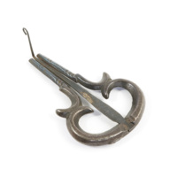 Jew&#039;s harp. A small teardrop shaped loop of grey metal with a thin strip of metal extending from the widest part of the loop to where its ends meet.