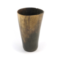 Cup. A plain cup made of a large piece of horn, with a glass bottom.