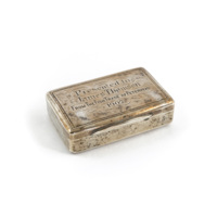Snuff box. A rectangular, silver snuff box about 5 centimetres long. It is inscribed Presented to James Thomson FROM THE FISH TRADE OF PETERHEAD 1907.