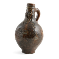 Bellarmine wine jar. A fat mottled brown ceramic bottle with a handle, a rose stamped on the middle, and on the neck a face of an elderly bearded man with bushy eyebrows.
