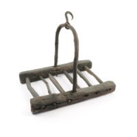 Kelchin. A large, square wooden rack about a foot wide with a handle and hook for hanging.