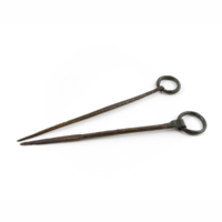 Shroud pins. Two long bronze pins with looped ends holding a ring.