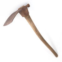 Adze. An adze with a wide, flat rusty iron head and a wooden handle.