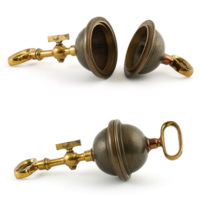 Magdeburg hemispheres. Two dark brass hollow hemispheres which fit together, with bright brass handles projecting from the top of each hemisphere. One has a short handle, the other has a long handle with a valve.