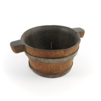 Bicker tarty. A tub shaped bowl made of staves of dark wood bound with two iron bands. Rounded blocks project from two of the staves opposite each other making the handles.