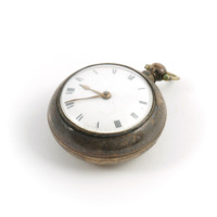 Watch. Tarnished silver pocket watch with copper hands and white clockface with roman numerals.