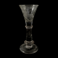 Goblet. Narrow, fluted glass goblet with a thick stem, engraved with an inscription and a man riding a horse.