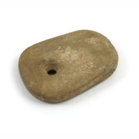 Pendant amulet. A small, flat rounded rectangular piece of beige stone with a circular hole drilled in one end.