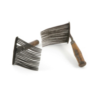 Heckle combs. Two large combs with long, fine, slightly curved metal teeth on wooden handles.