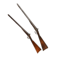 Shotguns. Two double barrelled shotguns, decorated with scrolls and foliage on the metal plates around the triggers.