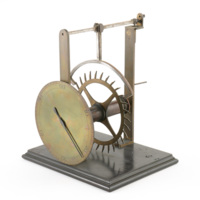 Graham&#039;s deadbeat escapement model. Brass model of an escapement consisting of a 60 second clock face behind which is a toothed wheel which is struck alternately by the ends of a curved brass arm connected to a spindle. The spindle would have a pendulum attached to it.