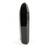 Cairngorm gem. Polished black gem, about 9 inches tall, the shape of a hexagonal prism with a pointed top.