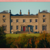 A large, symmetrical neoclassical mansion with columns supporting the roof of the porch.