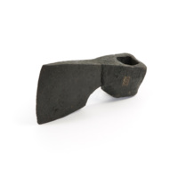Axe head. A heavy, black iron axe head with a square loop at the back to insert a handle.