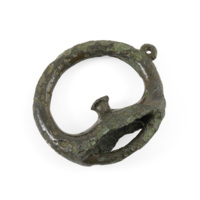 Terret. A bronze ring covered in a dark, smooth green patina. It has a small ring on one side. At the bottom of the main ring wide arms project from the sides and meet in the middle, curving up to a peg like projection.