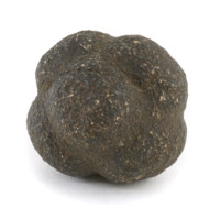Carved stone ball. Roughly the size of a tennis ball. Black, coarse stone ball with six large squarish knobs equidistant from one another.