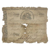 Bank note. A tattered paper bank note for one pound with creases and tears from being folded many times.