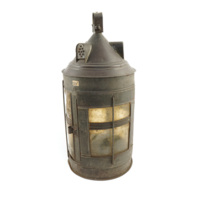 Lantern. Cylindrical tin lantern, about a foot tall, with a conical roof and windows made of flattened sheets of horn on the sides.