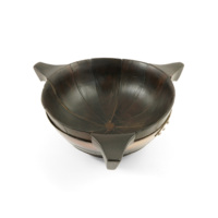 Quaich. A large bowl made of twelve curved triangular segments of wood, fastened together with a silver band. The quaich has three blocky handles which project from segments equidistant from each other.