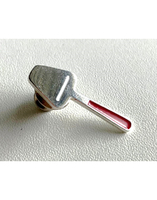 Pin in the shape of a cheese slicer, a small silver metal object with a red handle.