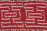 Garter Close Up. Close up of beaded and woven garter with white beads and burgundy yarn.